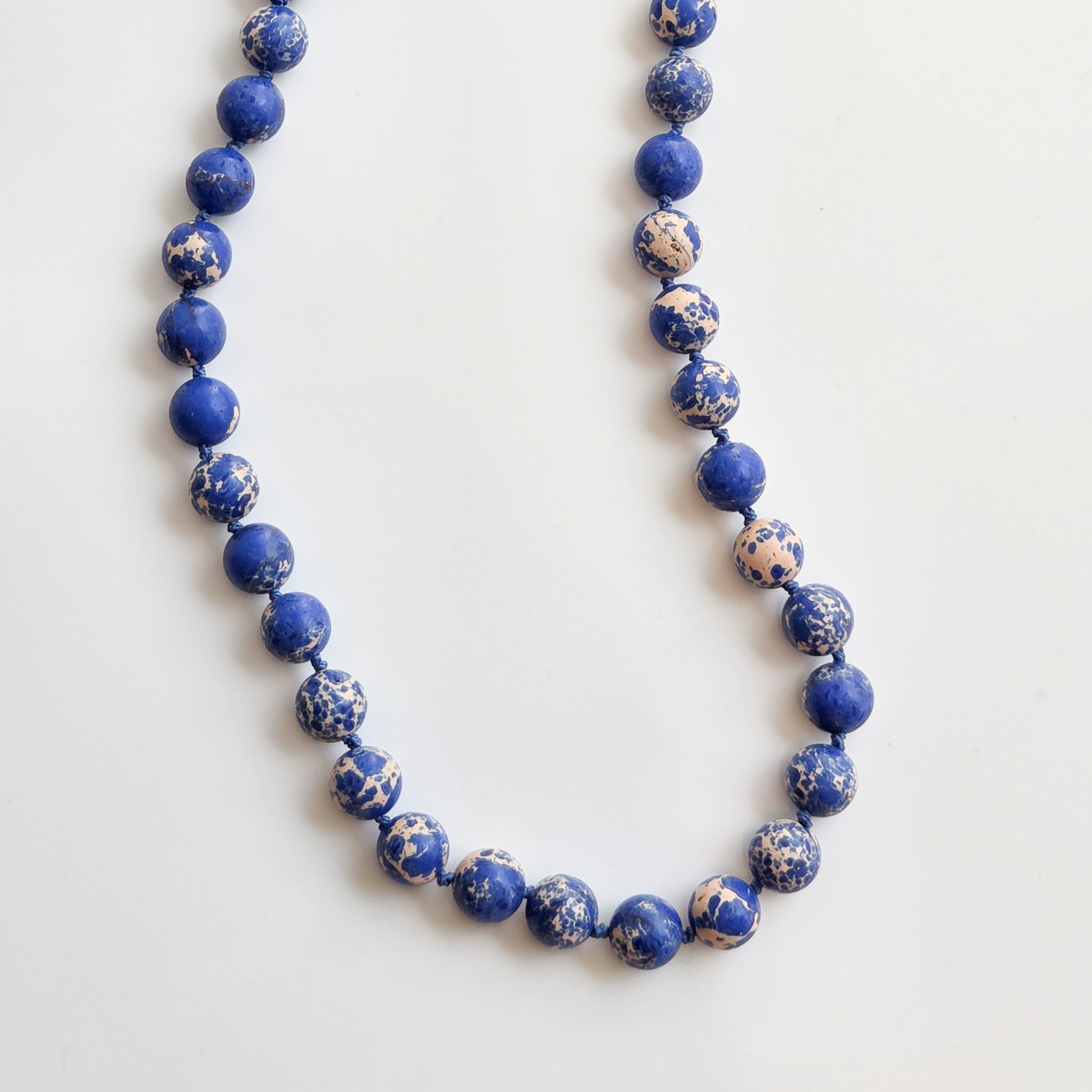 Necklace with blue beads on a white background